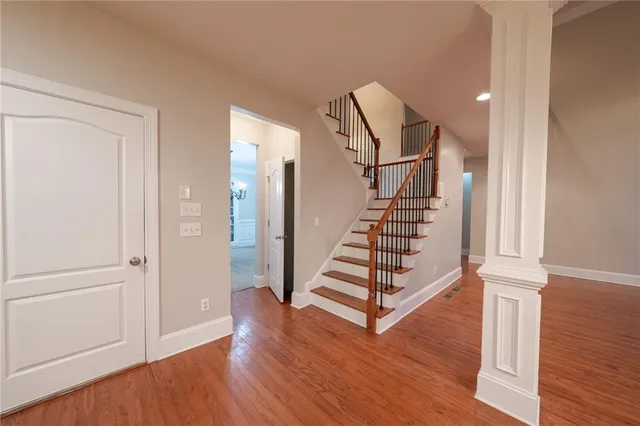 a view of entryway with wooden floor and stairs