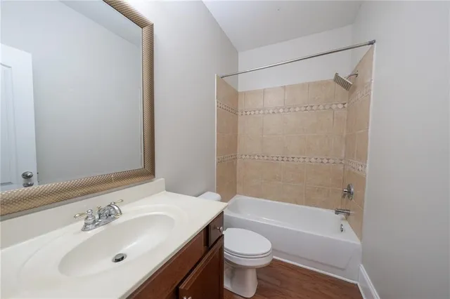 a bathroom with a sink mirror toilet and bathtub