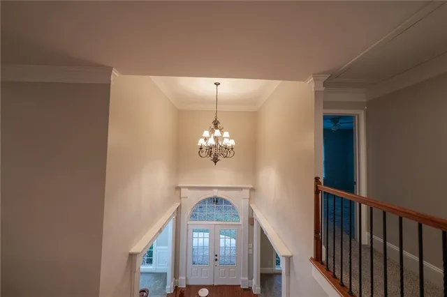 an empty room with a windows and a ceiling fan
