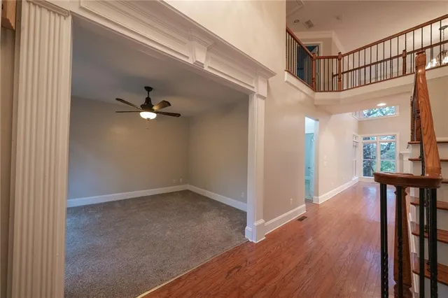 a view of a hallway with entryway and wooden floor