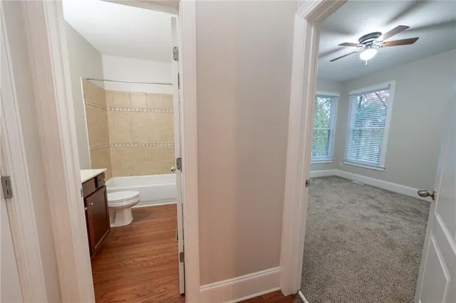 view of a bathroom with a toilet a sink and a mirror