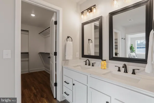 a bathroom with a double vanity sink mirror and