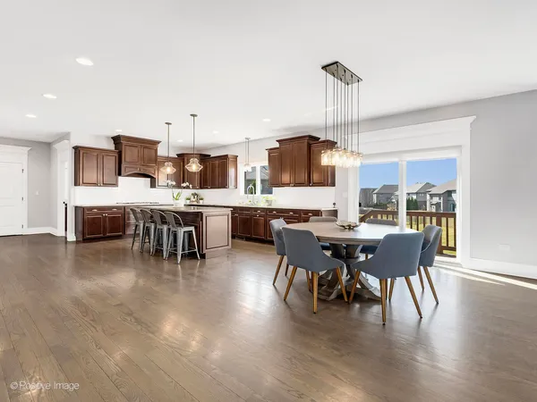 a dining room with furniture wooden floor a rug and a painting