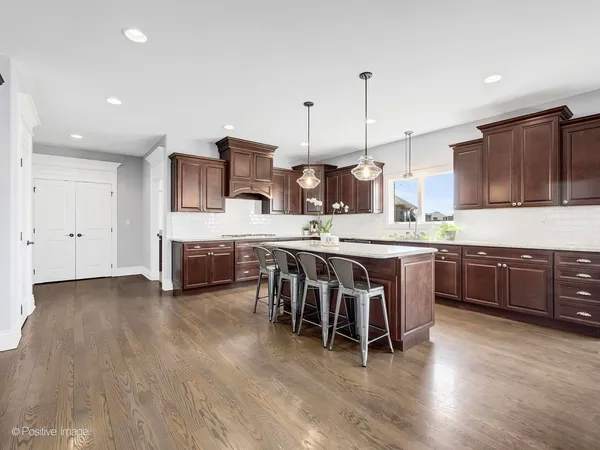 a kitchen with stainless steel appliances kitchen island granite countertop a stove a sink and a microwave