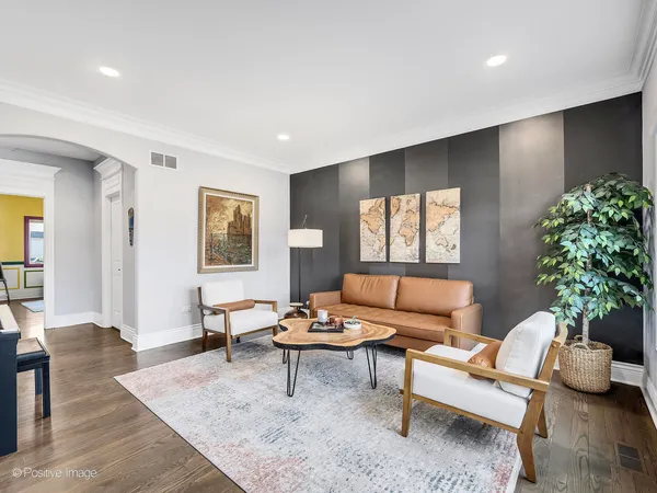 a living room with furniture and a potted plant