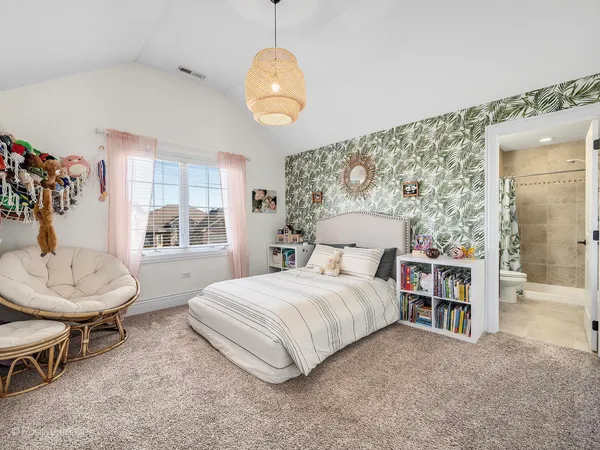 a bedroom with a bed and a chair