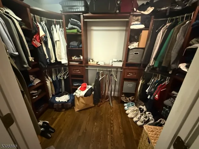 a view of walk in closet with clothes and shoes