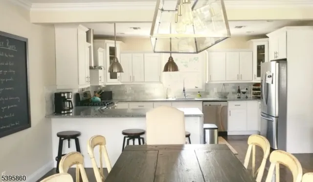 a kitchen with stainless steel appliances granite countertop a sink and refrigerator