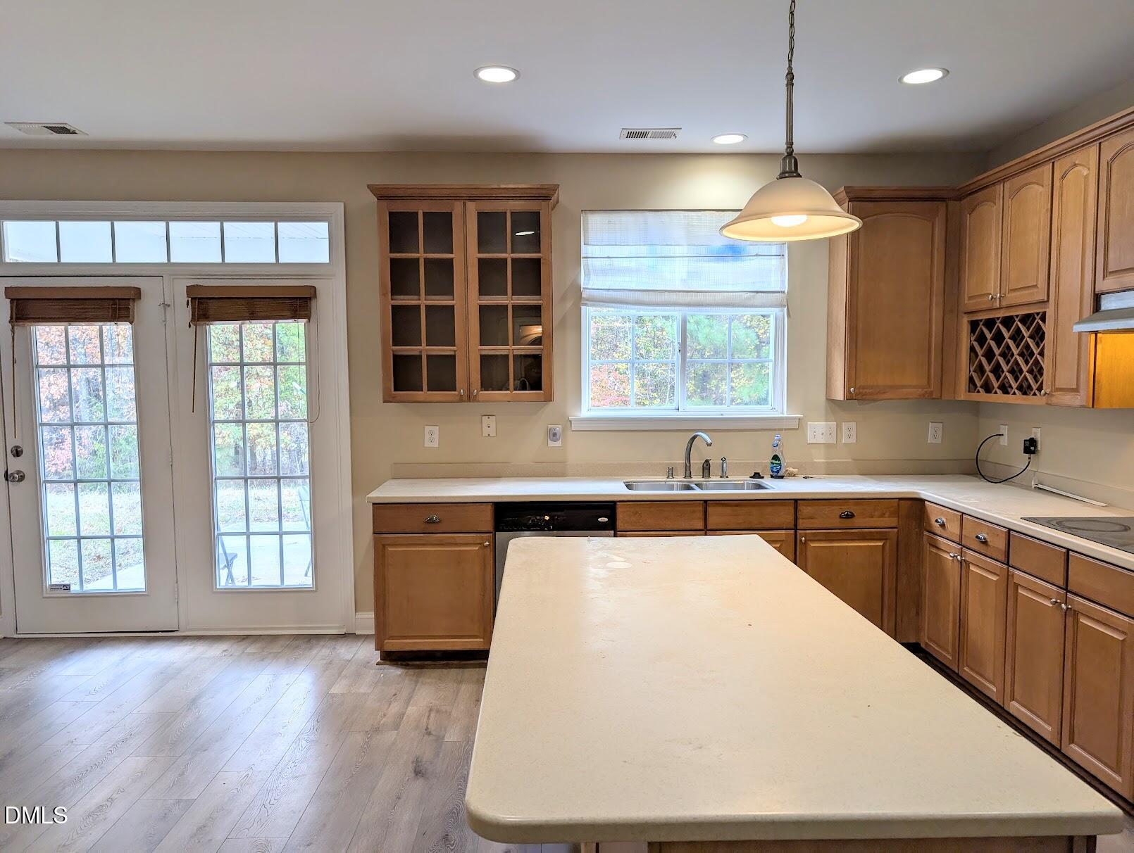 314 Ashburn Lane Durham, NC 27703 - Photo 11 of 40 a large kitchen with kitchen island granite countertop a stove a sink and dishwasher wooden cabinets with wooden floor
