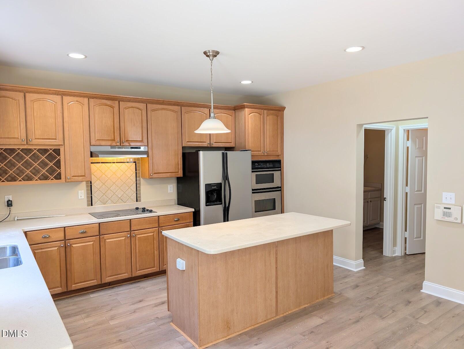 314 Ashburn Lane Durham, NC 27703 - Photo 12 of 40 a large kitchen with stainless steel appliances a large counter top a sink a refrigerator and a window