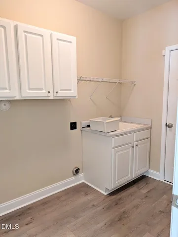 a view of a kitchen with white cabinets