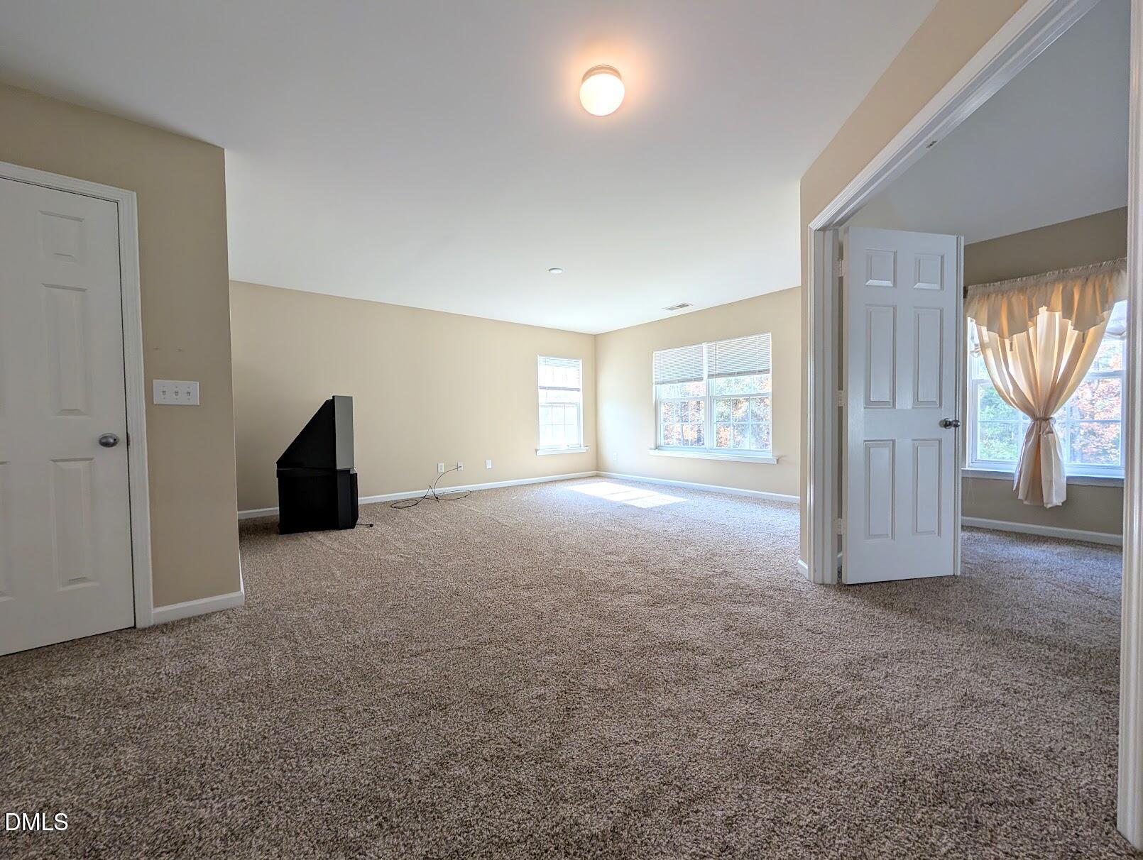 314 Ashburn Lane Durham, NC 27703 - Photo 19 of 40 an empty room with windows and closet