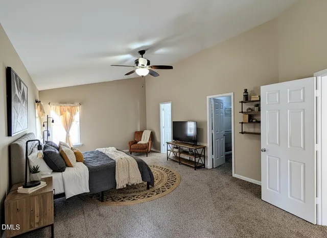 a bedroom with furniture and a flat screen tv