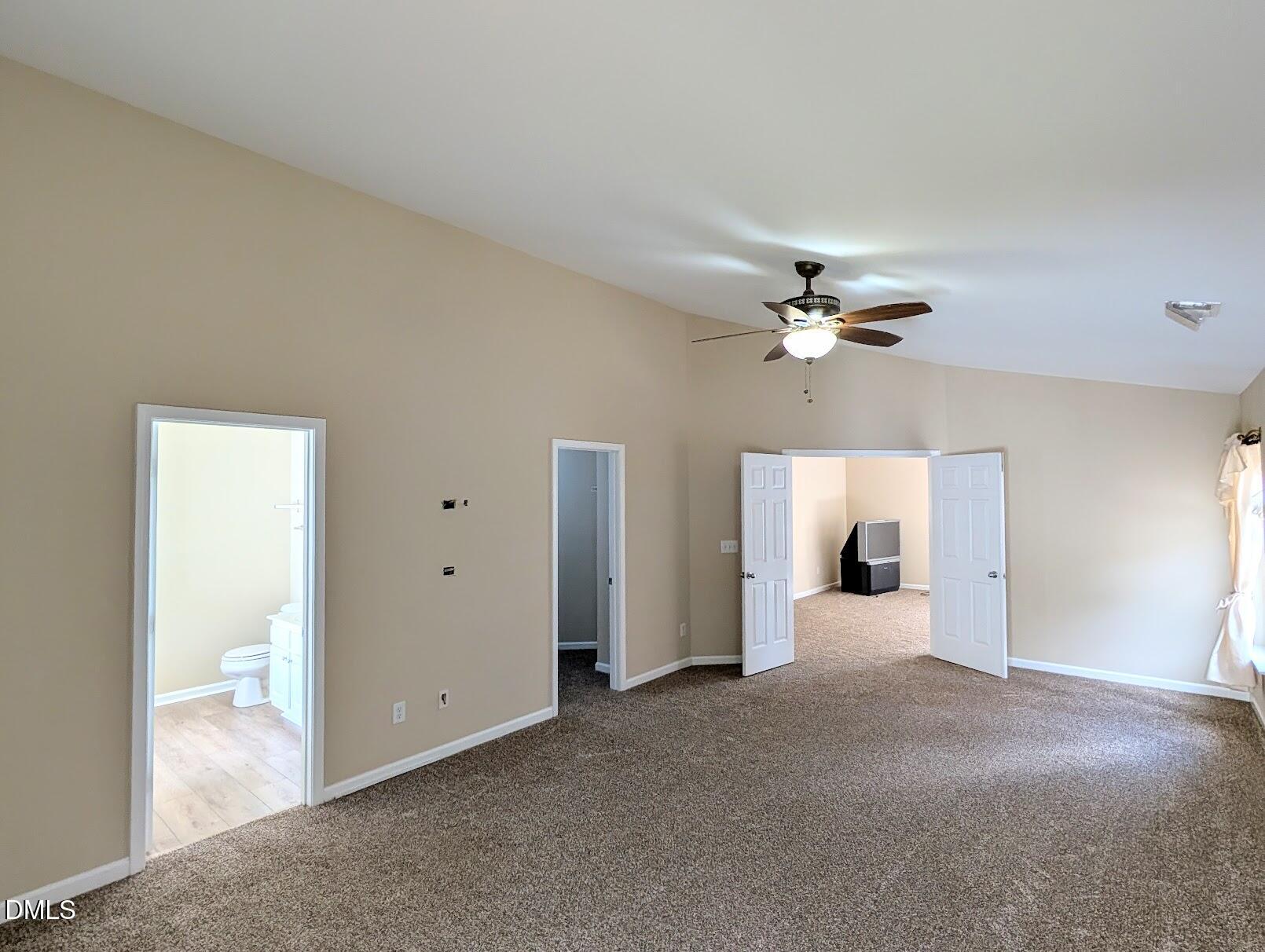 314 Ashburn Lane Durham, NC 27703 - Photo 25 of 40 a view of a room with a ceiling fan and a bathroom