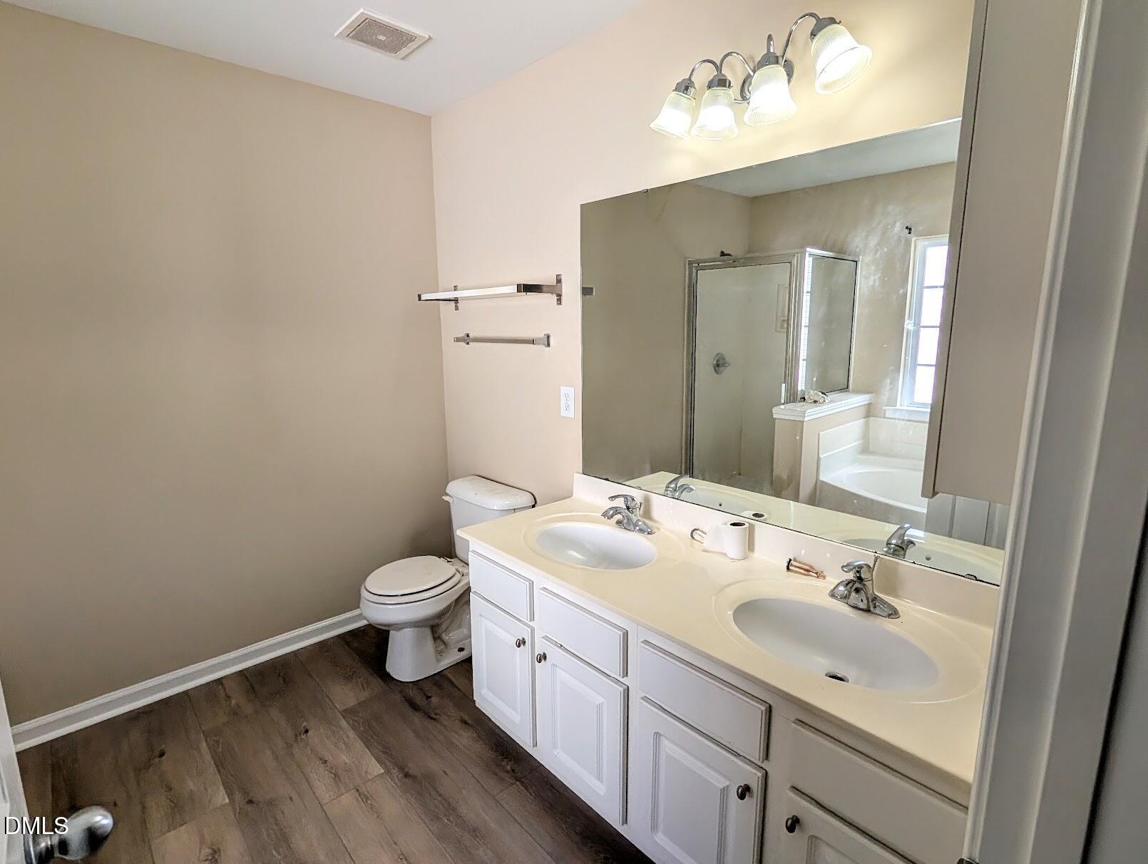 314 Ashburn Lane Durham, NC 27703 - Photo 27 of 40 a bathroom with a double vanity sink toilet and mirror