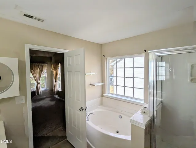 a bathroom with a bathtub and a shower