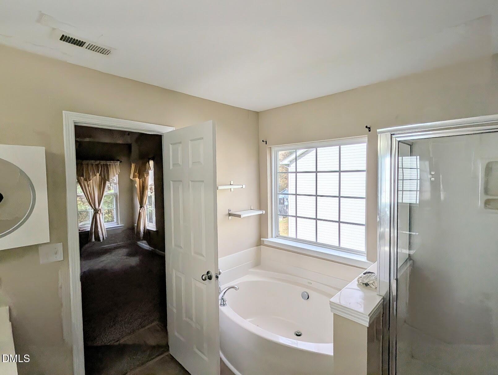314 Ashburn Lane Durham, NC 27703 - Photo 28 of 40 a bathroom with a bathtub and a shower