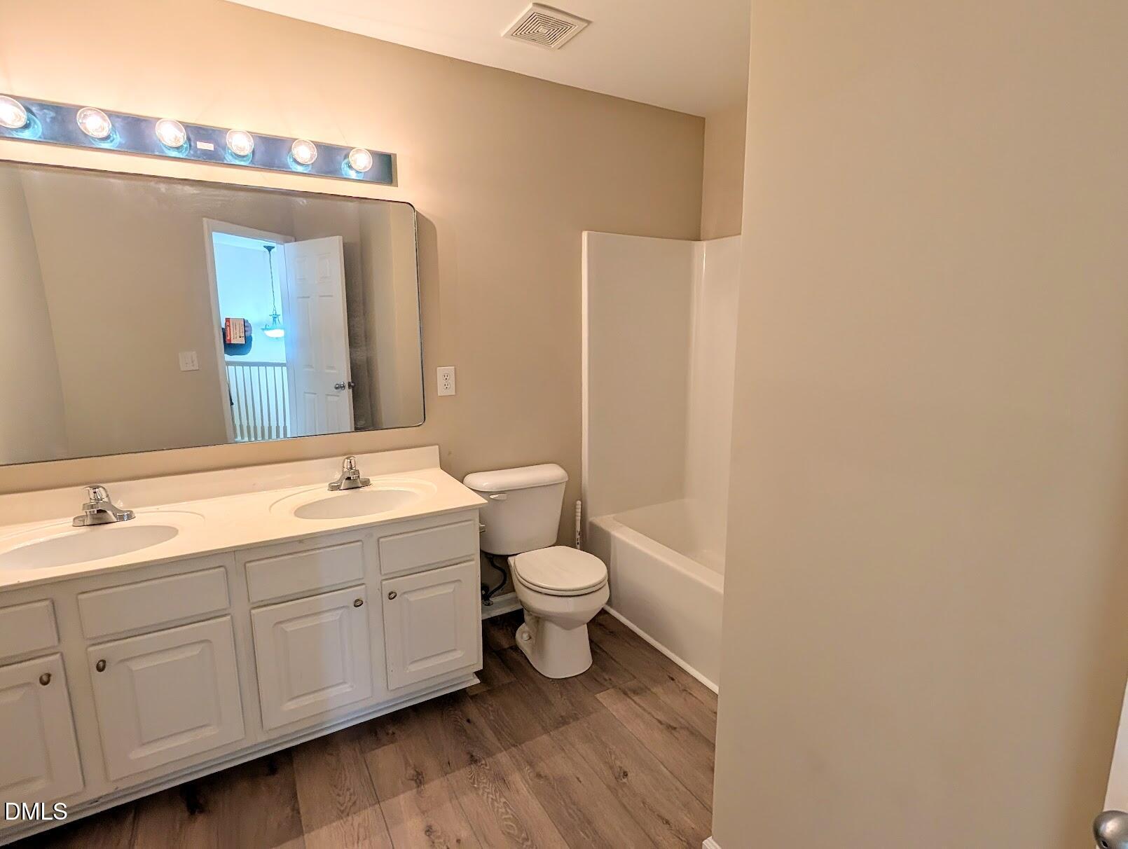 314 Ashburn Lane Durham, NC 27703 - Photo 33 of 40 a spacious bathroom with a double vanity sink a mirror and a toilet