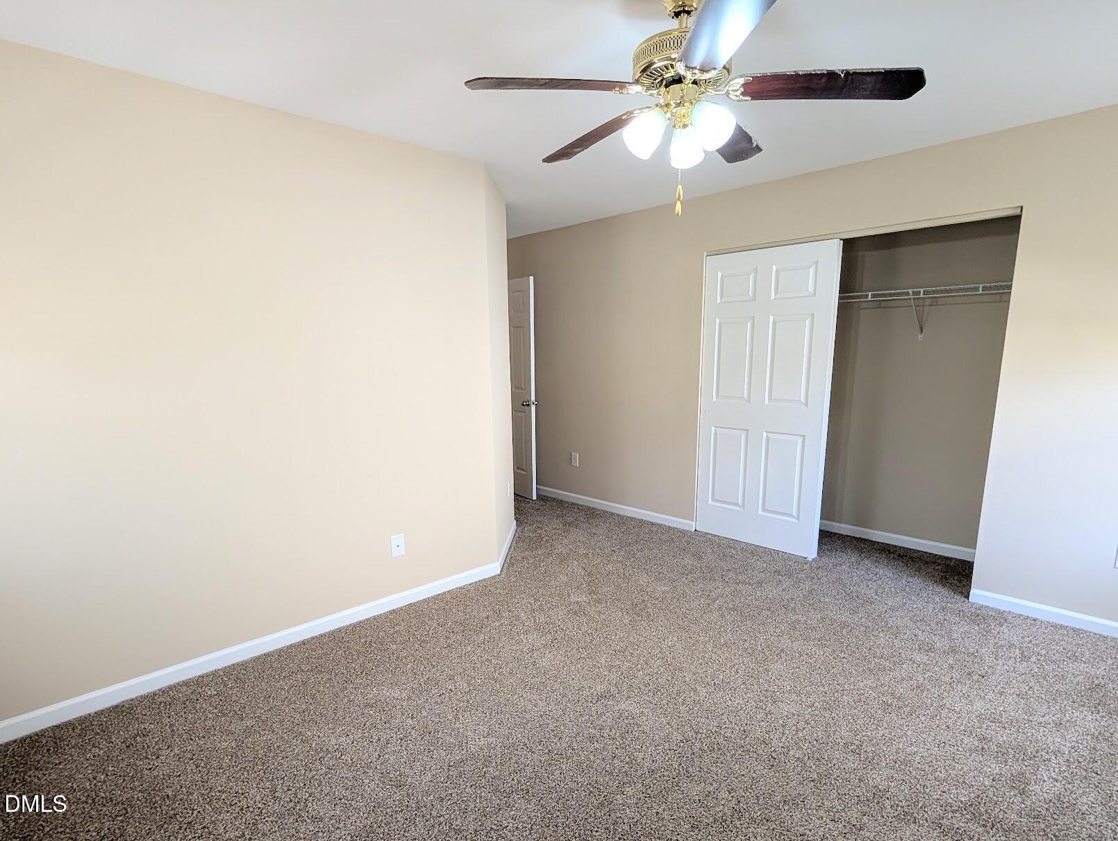 314 Ashburn Lane Durham, NC 27703 - Photo 40 of 40 an empty room with closet and a ceiling fan