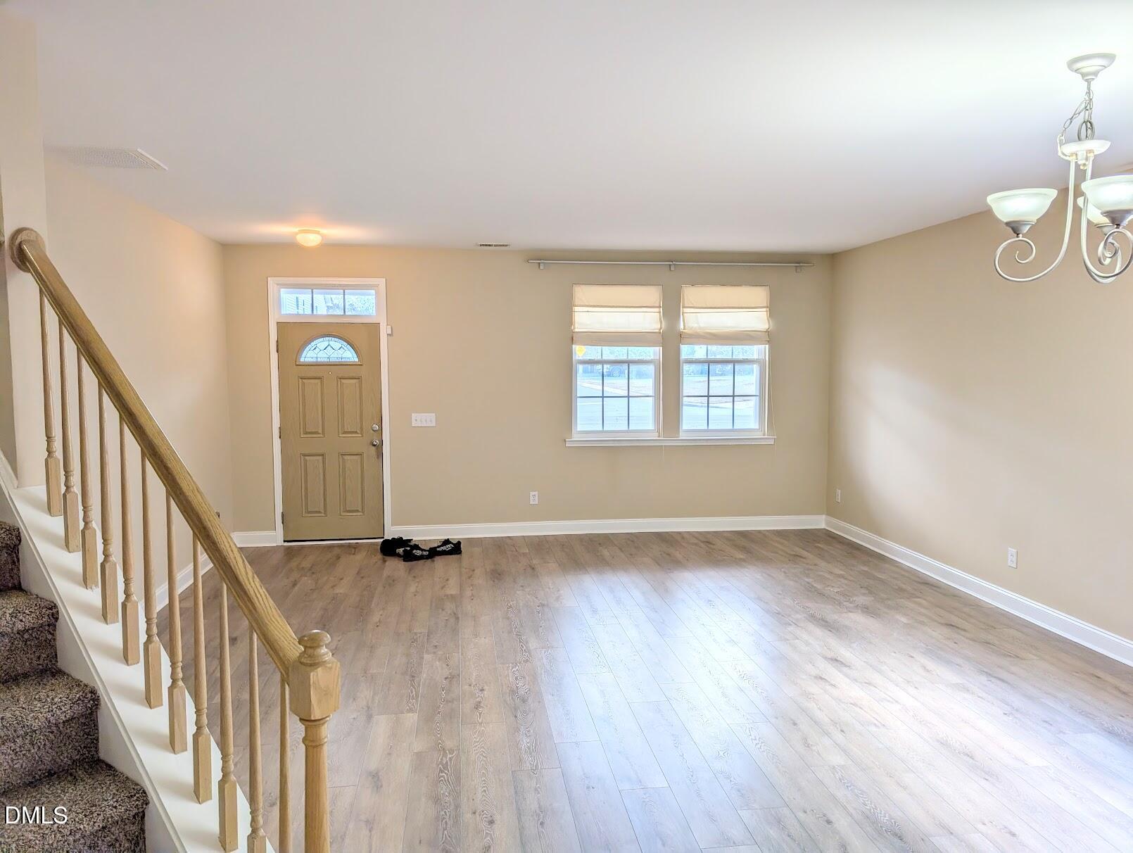 314 Ashburn Lane Durham, NC 27703 - Photo 7 of 40 a view of an empty room with wooden floor and a window