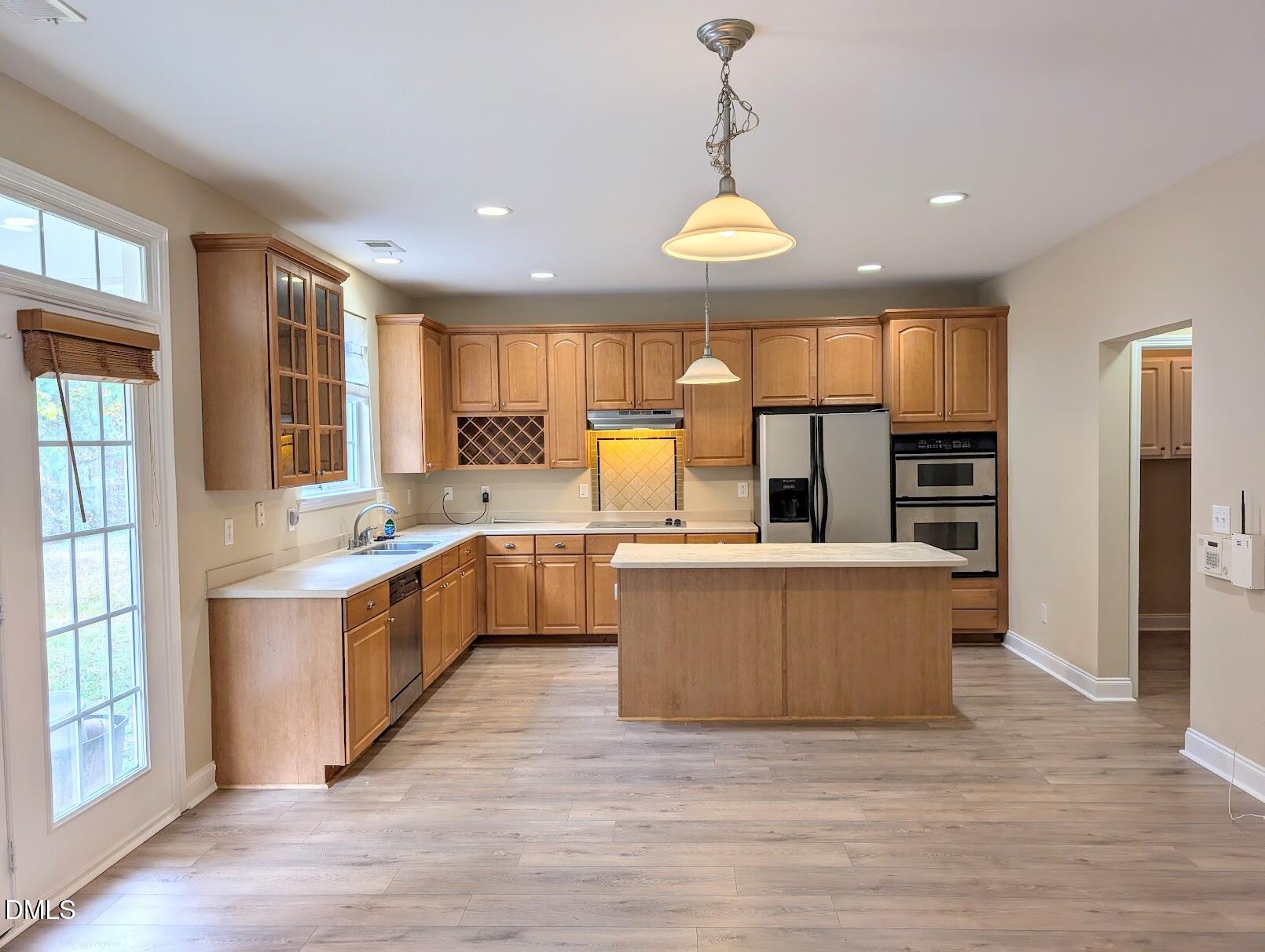 314 Ashburn Lane Durham, NC 27703 - Photo 9 of 40 a large kitchen with kitchen island a large counter top a sink stainless steel appliances and cabinets