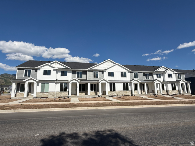 Modern townhome community featuring a combination of horizontal siding and stone veneer