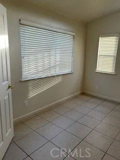 an empty room with a window and a ceiling fan