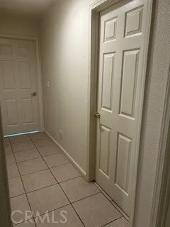 a view of an empty room with a fireplace and a window