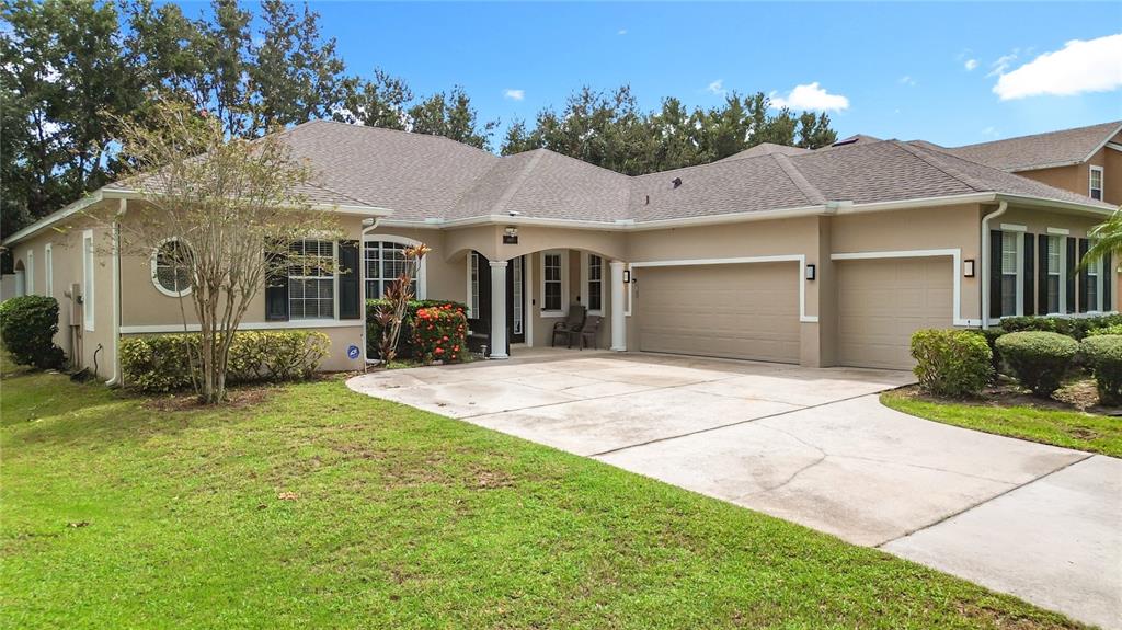 4837 Indian Deer Road Windermere, FL 34786 - Photo 1 of 1 a front view of a house with a yard and potted plants
