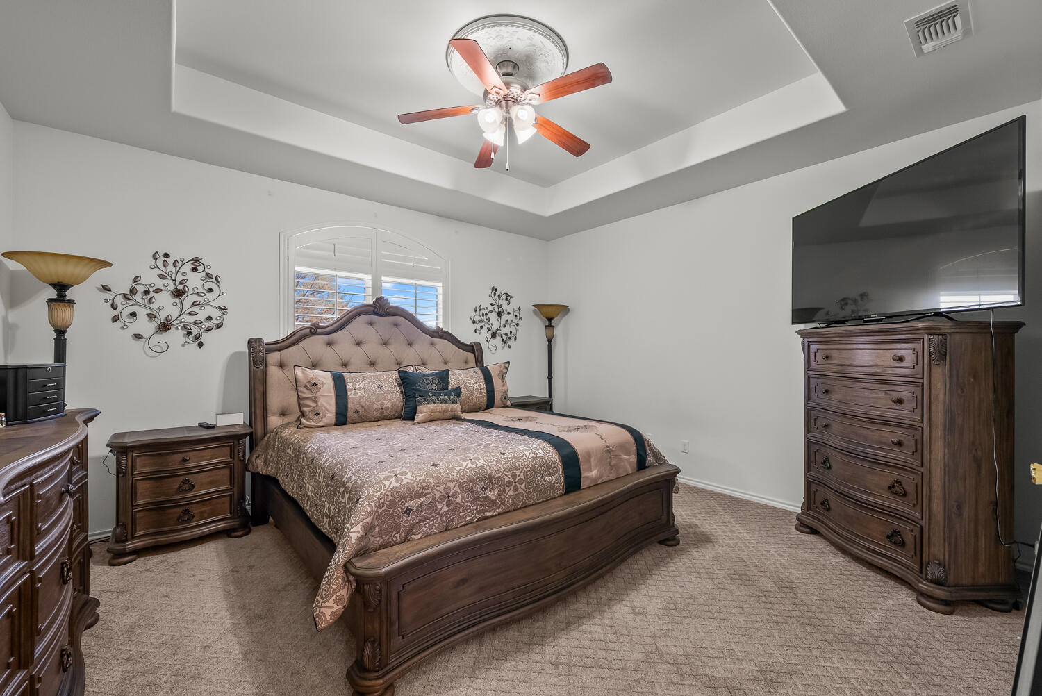 10508 Elgin Avenue Lubbock, TX 79423 - Photo 14 of 29 a spacious bedroom with a bed and a chandelier