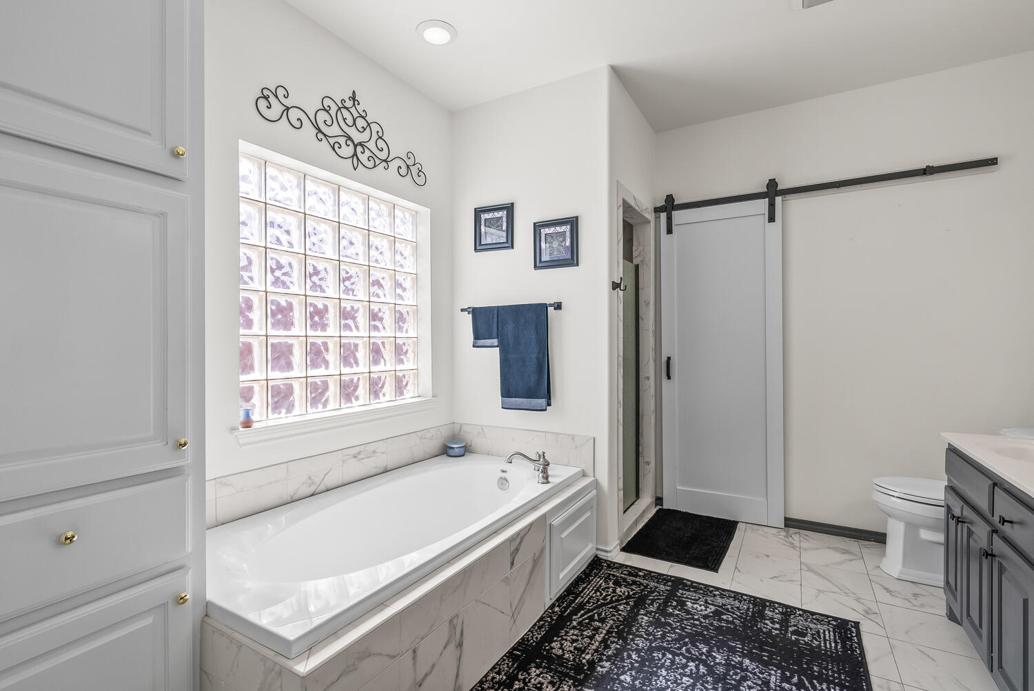10508 Elgin Avenue Lubbock, TX 79423 - Photo 16 of 29 a bathroom with a tub a sink and a shower