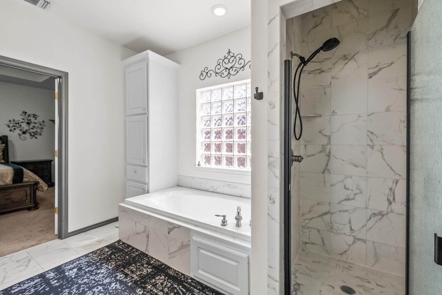 10508 Elgin Avenue Lubbock, TX 79423 - Photo 17 of 29 a bathroom with a bathtub and a shower