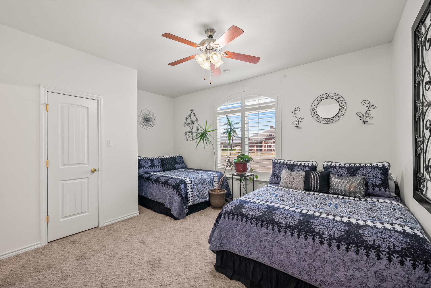 10508 Elgin Avenue Lubbock, TX 79423 - Photo 20 of 29 a bedroom with two beds and a chandelier