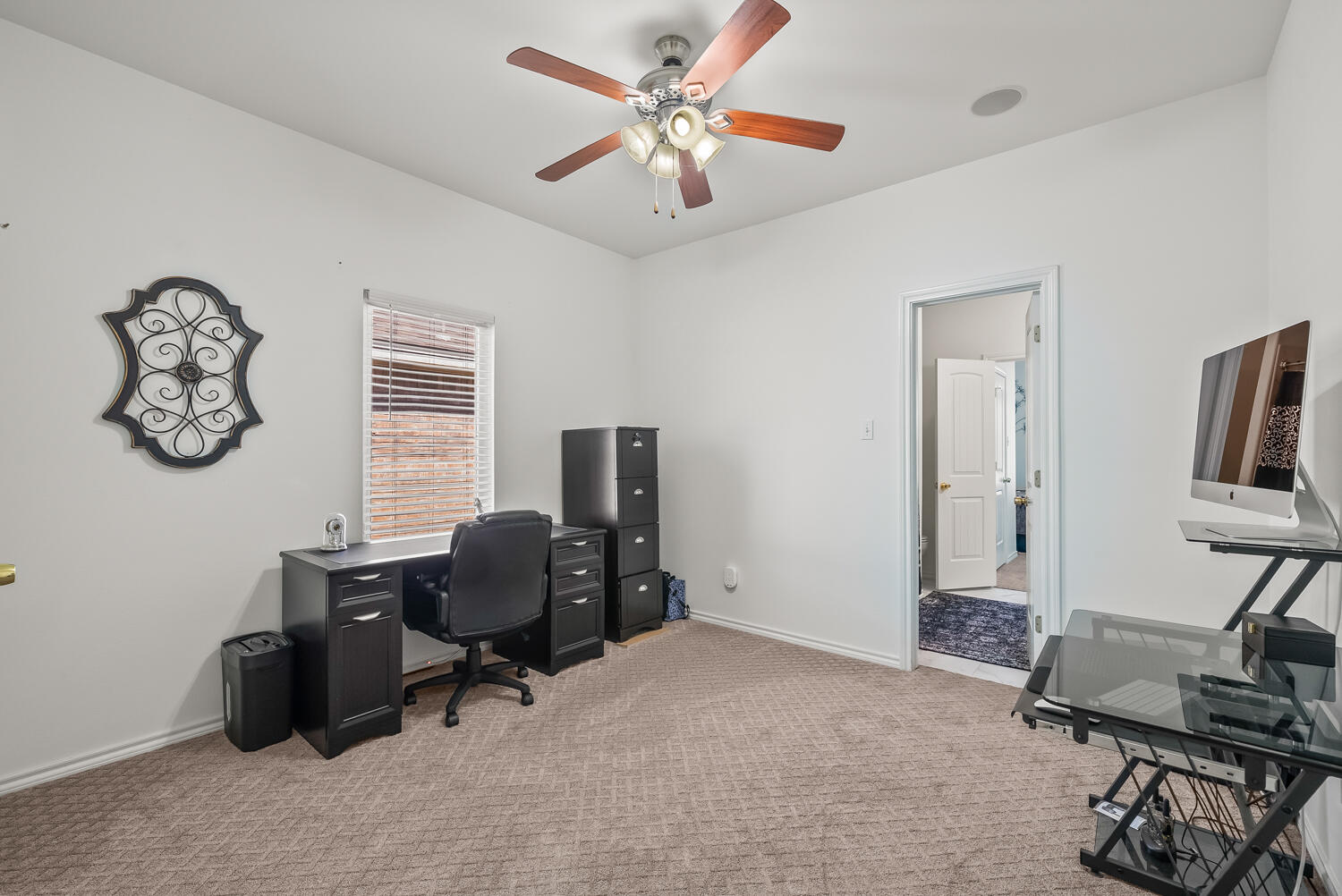 10508 Elgin Avenue Lubbock, TX 79423 - Photo 22 of 29 a view of a workspace with furniture and a window