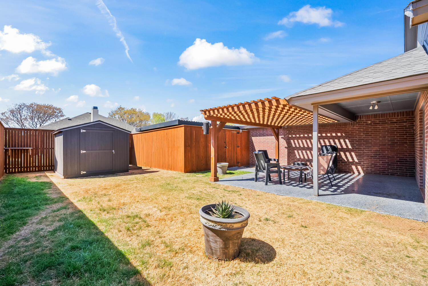 10508 Elgin Avenue Lubbock, TX 79423 - Photo 25 of 29 a view of a house with a patio and a yard