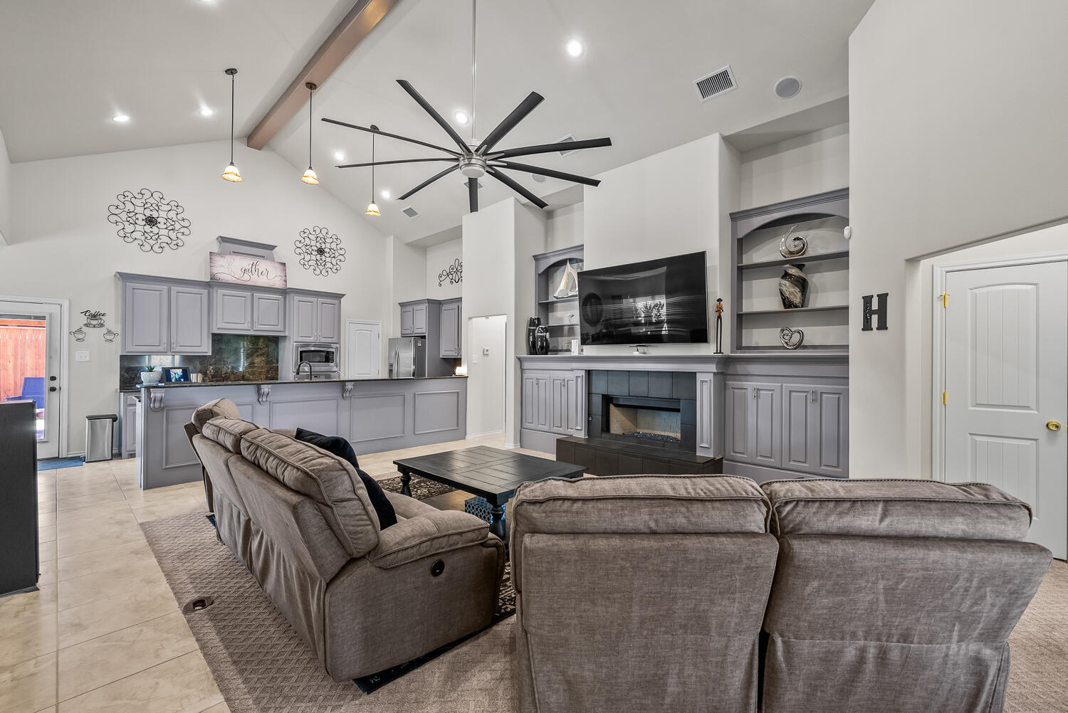 10508 Elgin Avenue Lubbock, TX 79423 - Photo 4 of 29 a living room with furniture and a flat screen tv with kitchen view