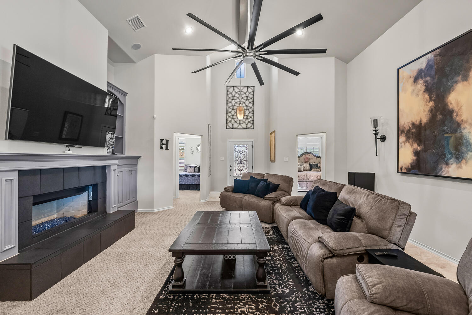 10508 Elgin Avenue Lubbock, TX 79423 - Photo 7 of 29 a living room with furniture a flat screen tv and a fireplace