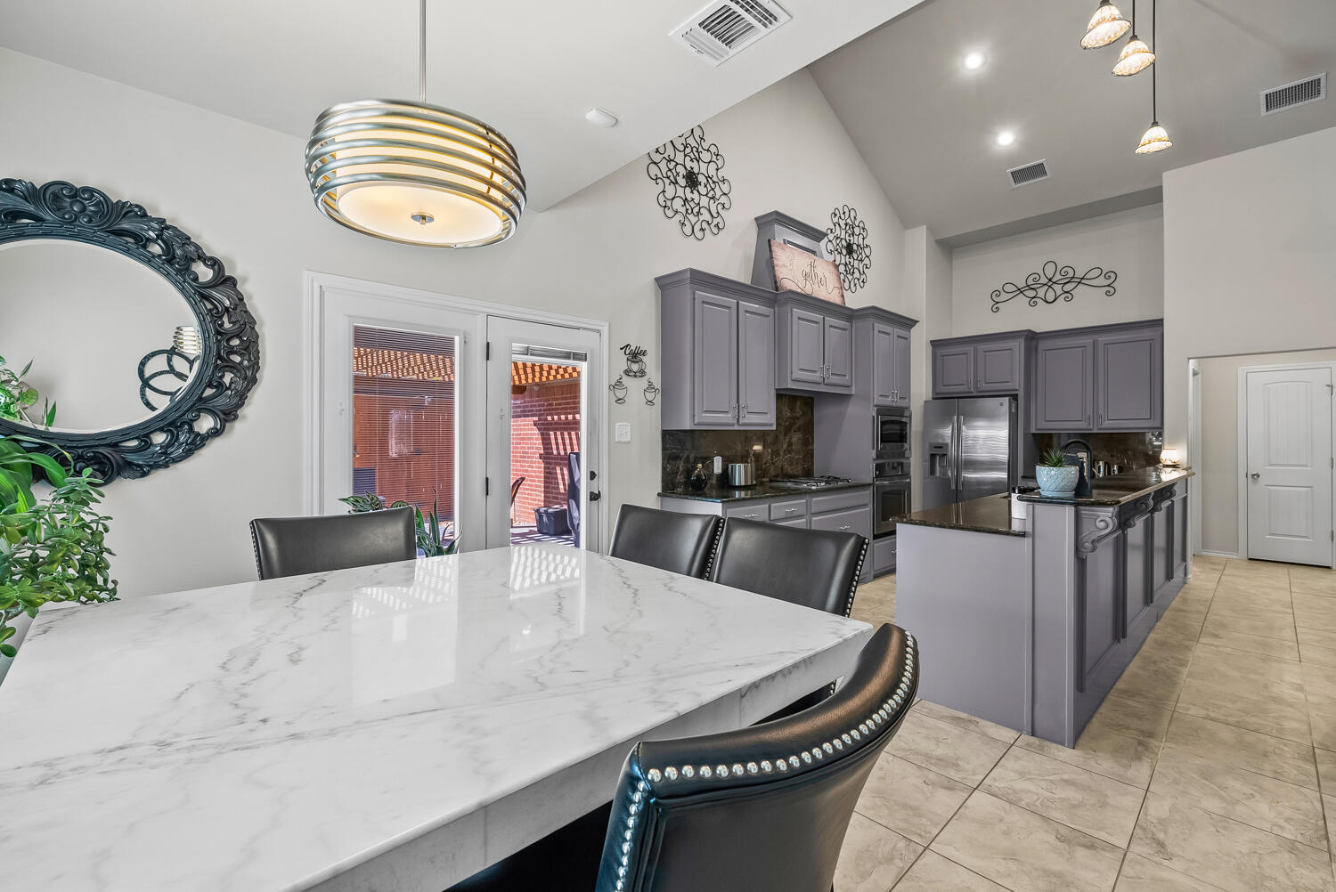 10508 Elgin Avenue Lubbock, TX 79423 - Photo 9 of 29 a kitchen with stainless steel appliances granite countertop a stove a sink a dining table and chairs
