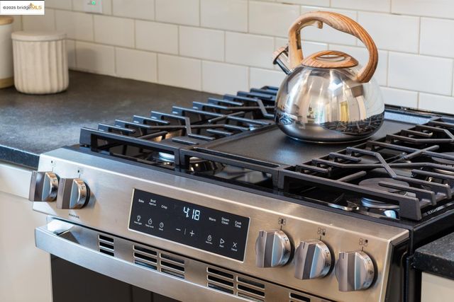 a kitchen with sink a stove and cabinets