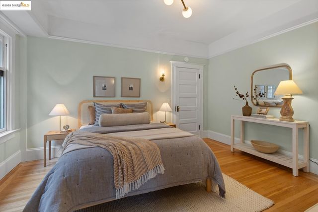 a spacious bedroom with a bed and wooden floor