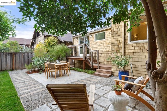 a view of a house with a table and chair in patio