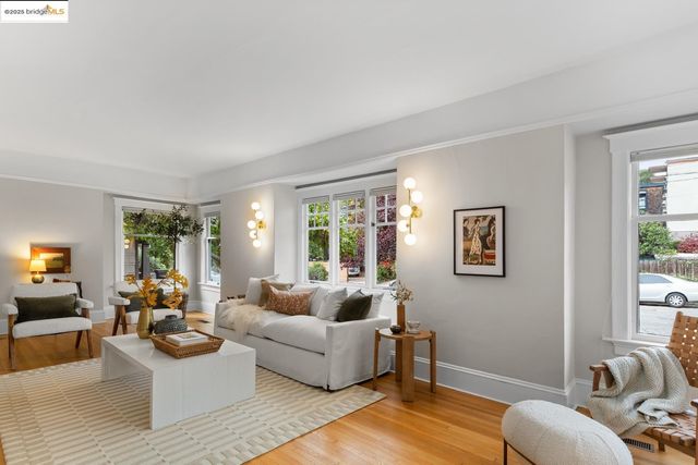 a living room with furniture a fireplace and a large window