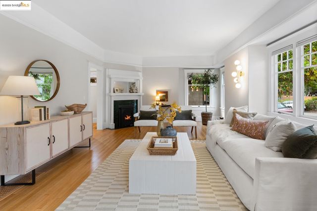 a living room with furniture a rug and a large mirror