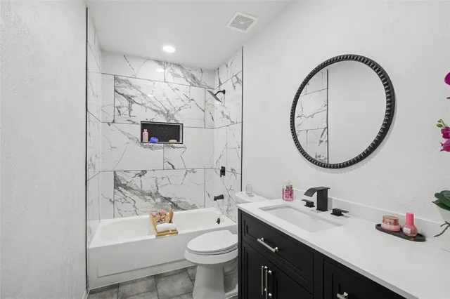 a bathroom with a sink a toilet and a mirror