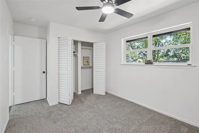 an empty room with windows and closet