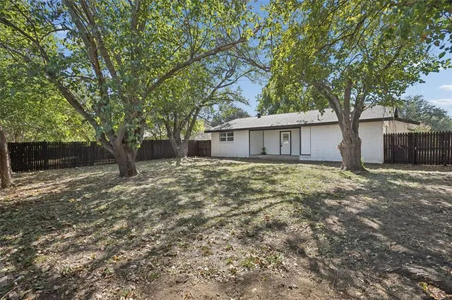 a front view of house with yard and trees