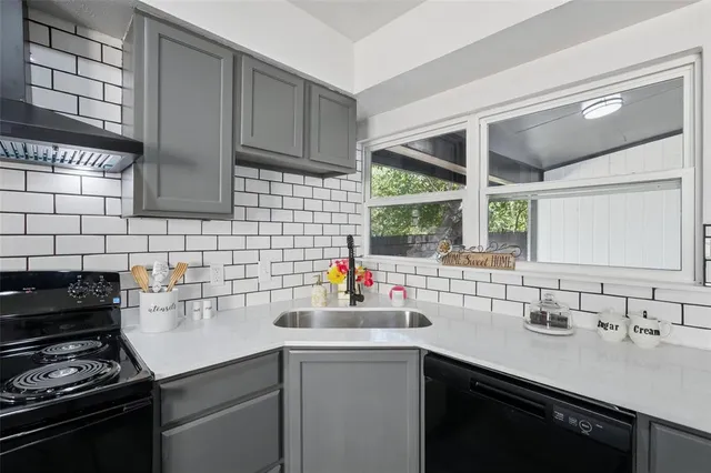 a kitchen with stainless steel appliances a sink stove and cabinets