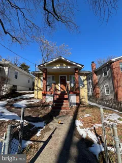 a view of a patio with table and chairs under an umbrella
