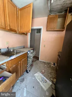 a kitchen with granite countertop a sink stove and cabinets