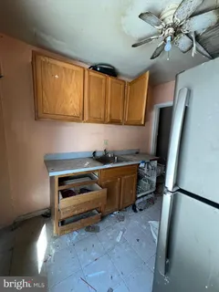 a room with chandelier fan and windows